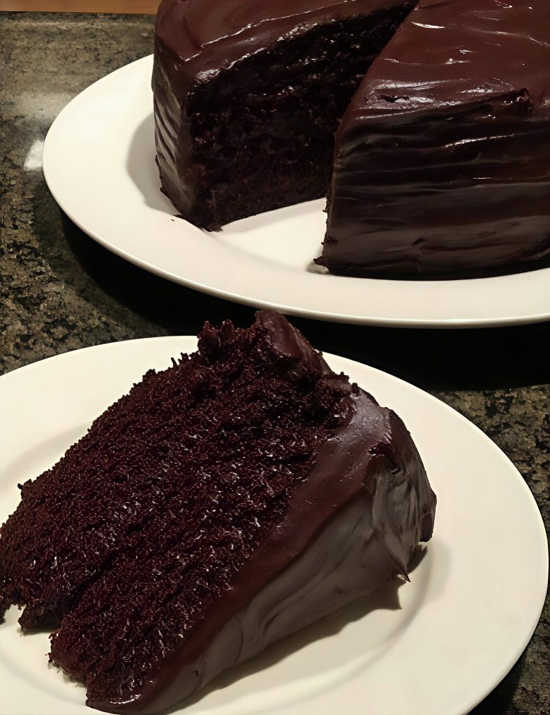 dark silk chocolate cake with glossy ganache and chocolate curls