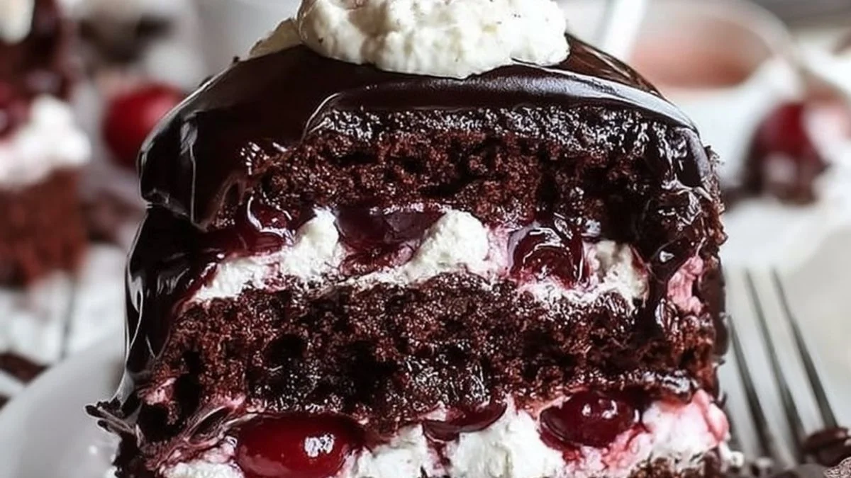 Black Forest Dream Slice 2 A slice of Black Forest Dream Slice featuring chocolate cake, whipped cream, and cherries