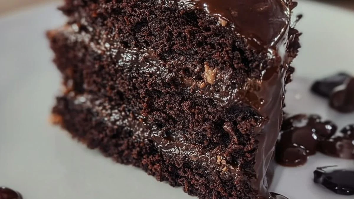 A decadent Midnight Chocolate Cake with glossy dark ganache dripping under soft candlelight.