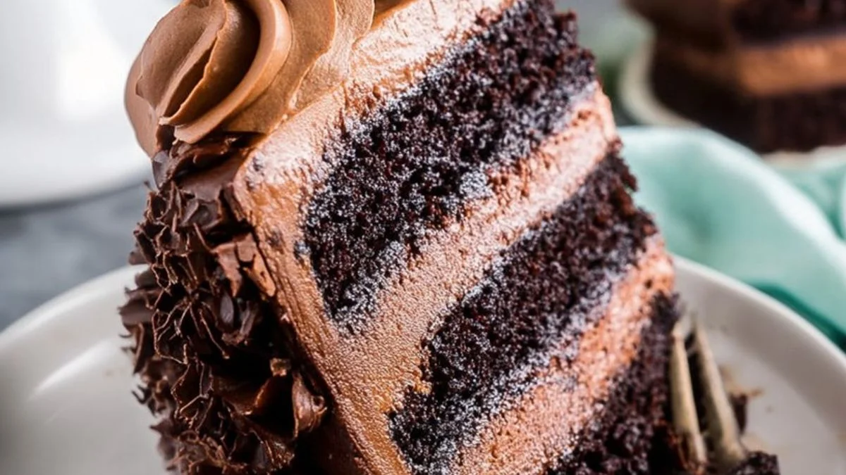 Close-up of rich Ultimate Chocolate Layers cake with glossy ganache drips and chocolate shavings