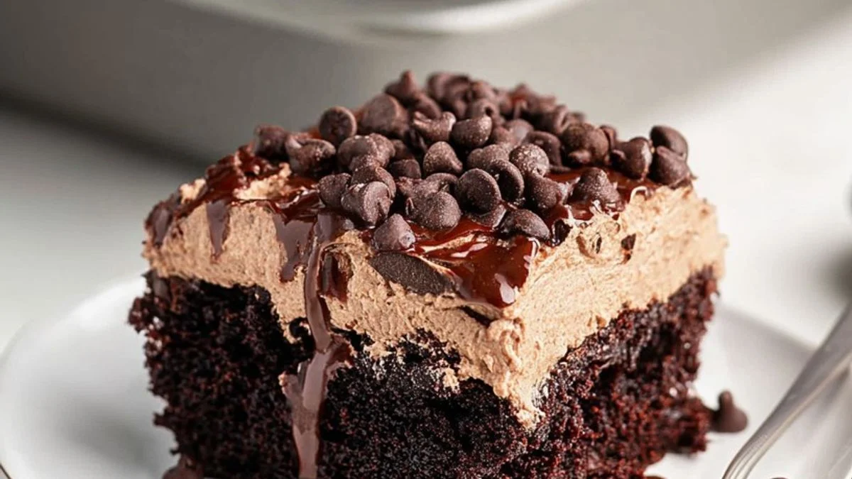 A slice of Triple Chocolate Dream cake showcasing rich dark ganache, smooth milk chocolate layers, and white chocolate curls on a marble slab.