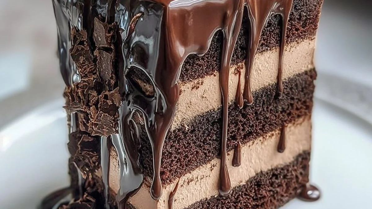 A decadent Triple Chocolate Mousse Drip Cake with glossy ganache drip, chocolate curls, and fresh berries