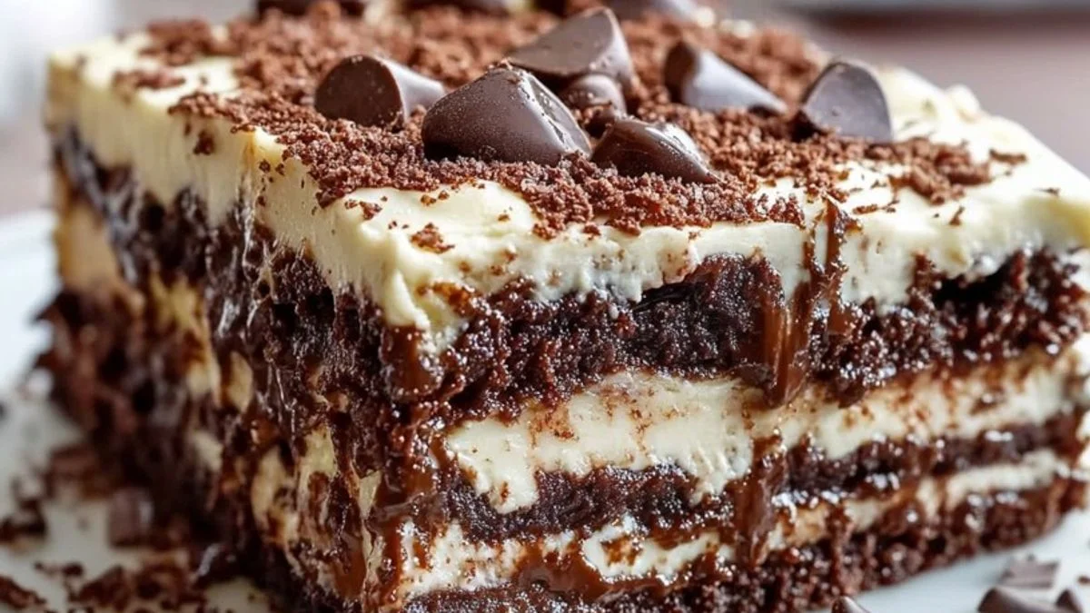 Close-up of a decadent Chocolate Layer Obsession cake with glossy ganache and fresh raspberries.
